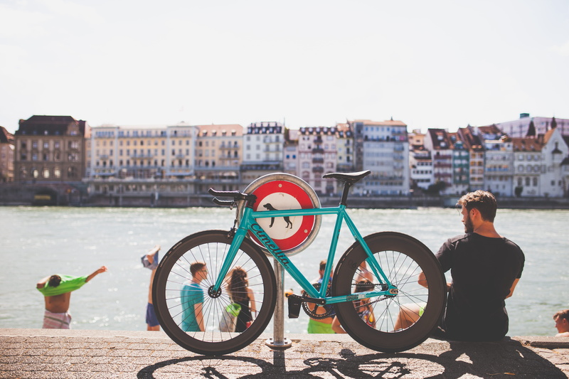 5K, building exterior, man, road, parking, one person, riverside, copy space, river, blue, near, day, outdoors, bike, beside, wheel, bicycle, transportation