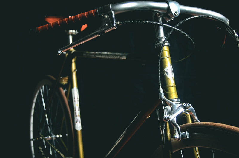 retro styled, photography, microphone, metal, gray, wheels, focus, stage, fixed, no people, black background, parking, land vehicle, bike, stationary, beige
