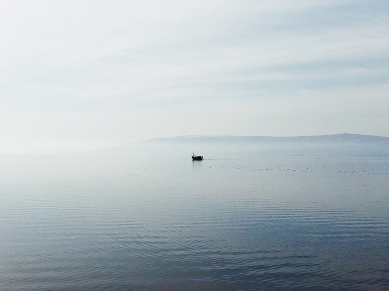 waterfront, fishermen, water, ocean, sea of galilee, idyllic, horizon, boat, outdoors, alone, sea, non-urban scene, fog, lake, sky, solitude, scenics - nature