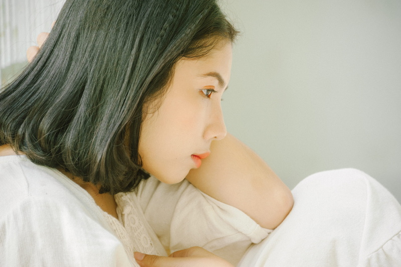 4K, hairstyle, shirt, white, emotion, child, indoors, sadness, one person, side view, sitting, girl, close-up, bedroom, looking away, room, woman, adult