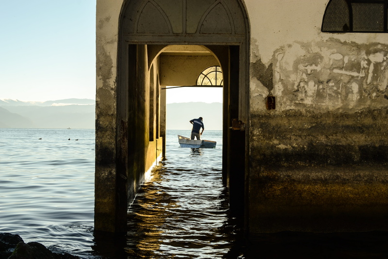 one person, atitlan, fish, sea, nature, guatemala, lake, beauty in nature, old, rear view, blue, built structure, fishing, day, standing, arch, 4K, architecture