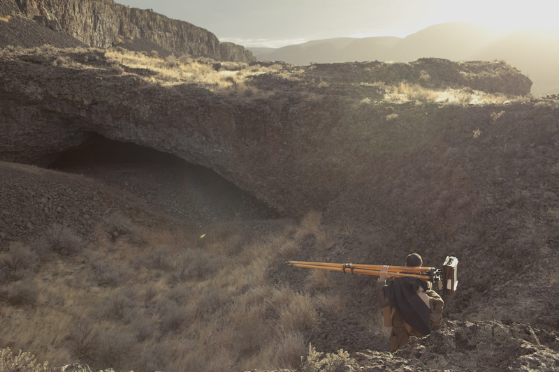 scenics - nature, tripod, camera, tranquility, day, solitude, formation, dirt road, alone, travel, field, rock, environment, beauty in nature, holding