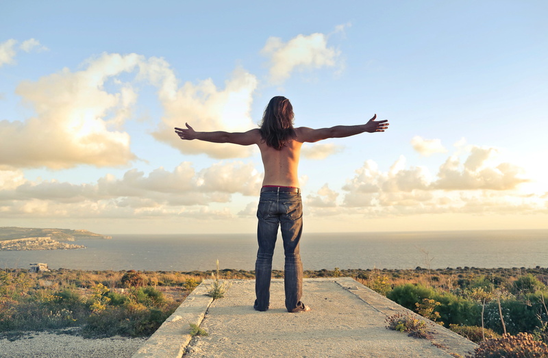 green, beauty in nature, one person, human limb, adult, outdoors, excitement, hands, body part, sunny, land, arms outstretched, youth, sea, cloud - sky