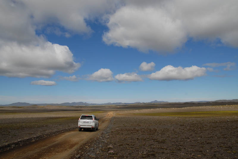 cloud - sky, wide open spaces, car, non-urban scene, transportation, land vehicle, desert, volcanism, outdoors, road trip, iceland, sports utility vehicle