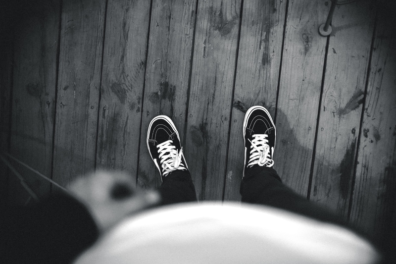 hand, look, feet, lifestyles, standing, shoes, van, indoors, bw, high angle view, focus on background, wood, flooring, black and white, 5K, down, photo
