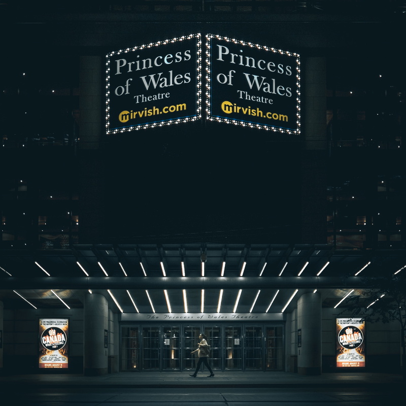sidewalk, night, cinema, person, travel destinations, entertainment, sign, building exterior, movie, information, illuminated, architecture, transportation