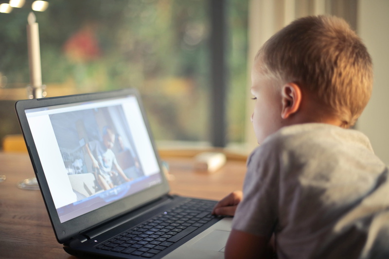 one person, looking, view, watching, little, lying, video, joy, technology, connection, male, 2K, pc, kid, focus on foreground, portrait, screen, child