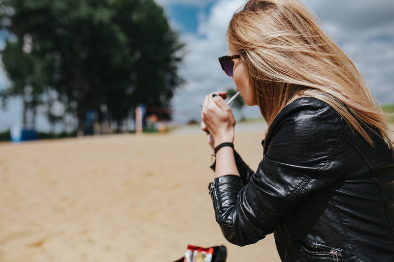 adult, headshot, one Person, blond Hair, hairstyle, female, relaxing, woman, caucasian Ethnicity, jacket, leisure activity, outdoors, technology, wearing