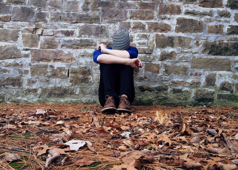 one person, day, twigs, leaf, wall, plant part, autumn, outdoors, depression, stress, young, urban, women, adult, loneliness, standing, street, hiding