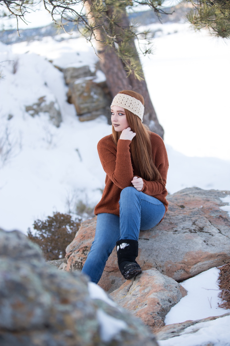 people, girl, lifestyles, rock, warm clothing, sitting, women, front view, day, one young woman only, hair, real people, beautiful woman, young, natural