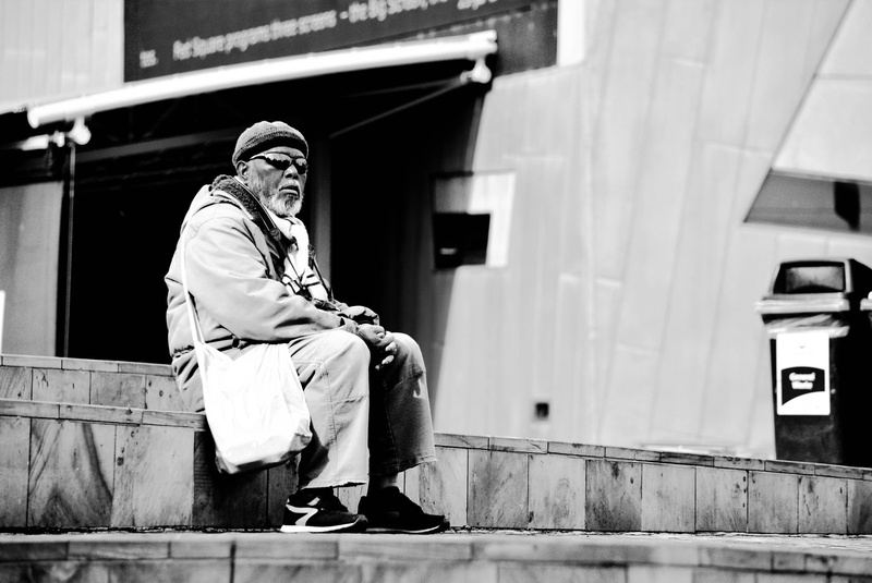 full length, chilling, sitting, grayscale, city, lonely, thinking, thoughtful, architecture, built structure, outdoors, real people, bright, chill, building