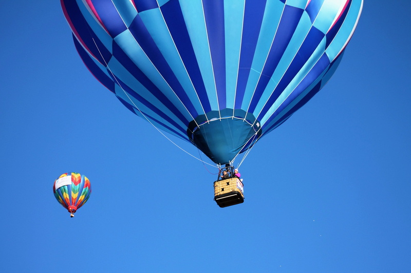 transportation, blue sky, flying, fly, multi colored, air, air vehicle, incidental people, mid-air, aerial, ride, low angle shot, bright, nature, colorful