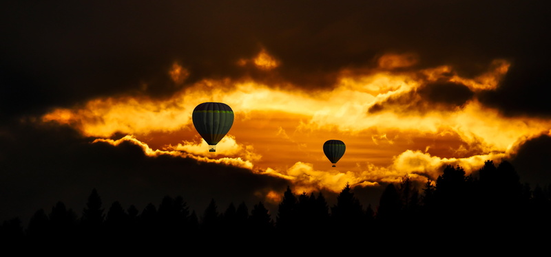mid-air, ballooning festival, no people, sustainability, orange color, air vehicle, travel, cloud - sky, clouds, adventure, relaxation, lighting, hot air balloon ride