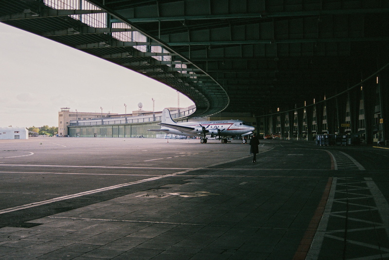 person, control tower, direction, nature, travel, human, connection, day, airport, tarmac, bridge, building, architectural column, airliner, tower, airport terminal