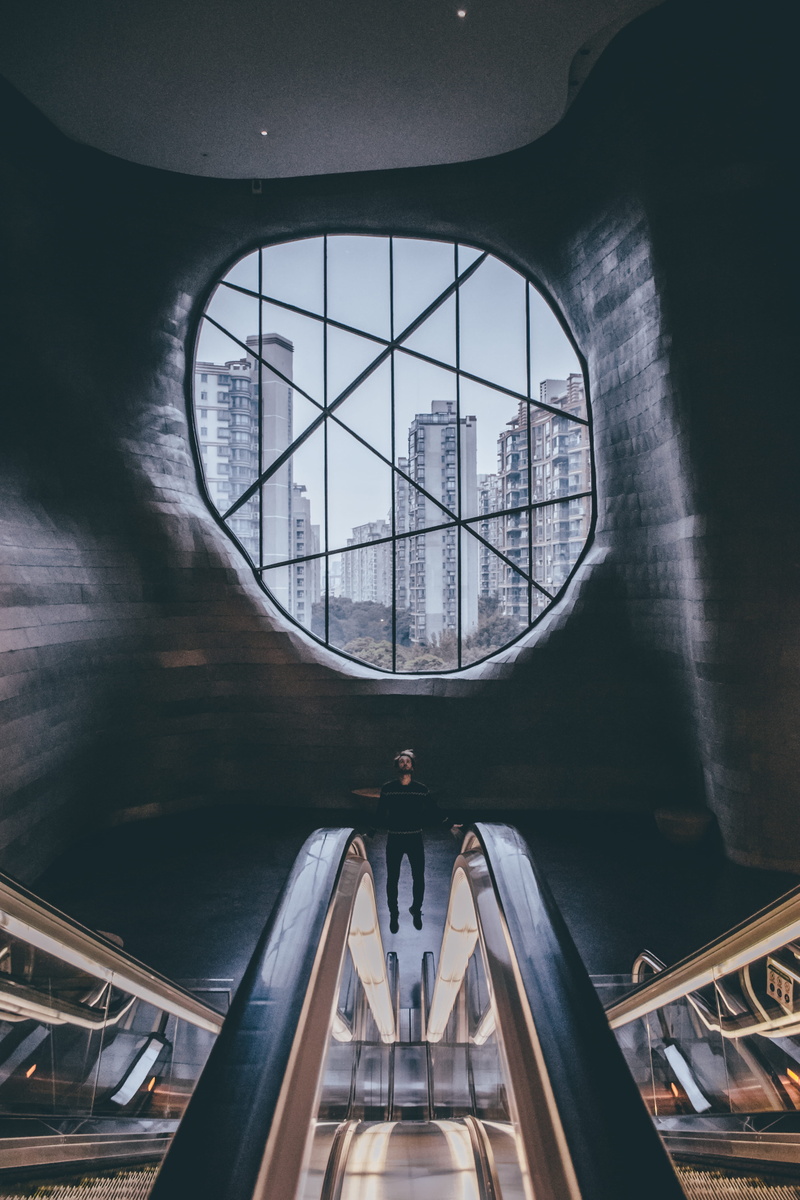 airplane, banister, ceiling, spaceship, building exterior, directly below, skylight, airliner, outdoors, design, tower, glass - material, human, hangar