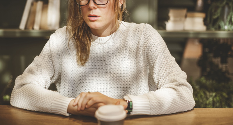 mug, beside, table, wear, coffee drink, beverage, waist up, front view, white, young women, beautiful woman, adult, indoors, eyewear, cup, delicious, one person