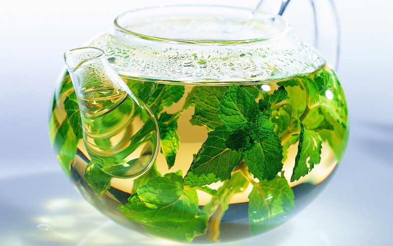 yellow, hot drink, indoors, tea cup, no people, liquid, glass - Material, clear, summer, glass, backgrounds, drink, green Color, tea, leaves, lemon, plant part