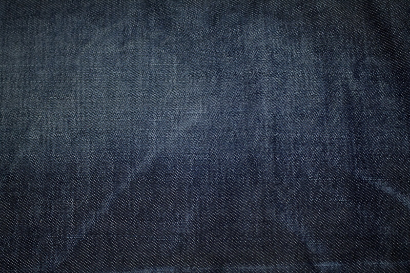 extreme close-up, textured, denim, wasing, 5K, abstract, textile, studio shot, texture, no people, textured effect, black background, garment, clothing