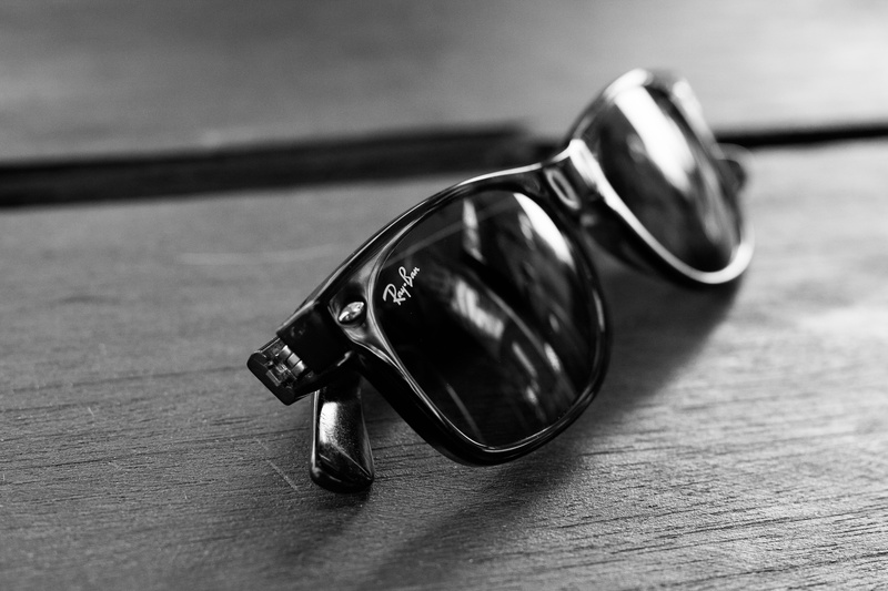 silver colored, glasses, high angle view, focus on foreground, close-up, wood - material, no people, selective focus, single object, still life, personal accessory