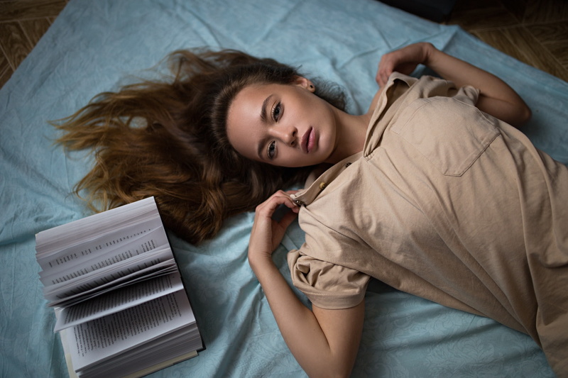 model, Ilya Baranov, looking at viewer, blouses, brunette, lying on back, in bed, top view, women, indoors, books, 1080P, women indoors
