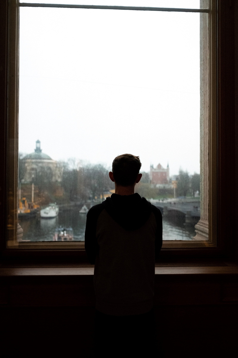 porthole, lifestyles, window, human, looking at view, person, curtain, one person, window shade, city, men, 4K, architecture, handrail, door, sky, building