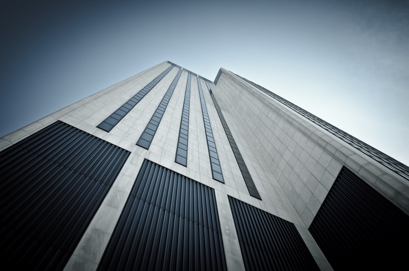 office building exterior, directly below, modern, day, black, clear sky, window, tower, sky, city, tall - high, vignette, white, low angle view, building exterior
