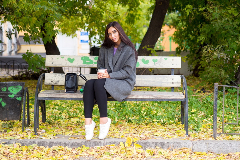 adult, casual clothing, outdoors, bench, day, real people, sitting, leisure activity, lifestyles, plant, women, young adult, one person, beautiful woman