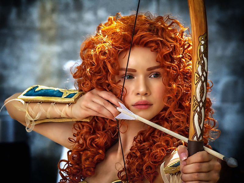lifestyles, redhead, mirida, indoors, holding, costume, bow, brown hair, style, curly hair, Archer, young adult, portrait, front view, one person, Merida