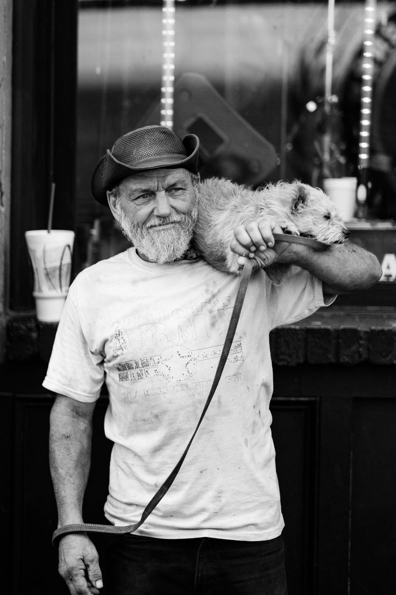 grayscale, day, black and white, real people, senior adult, mans best friend, standing, holding, nashville, pet, man, waist up, person, focus on foreground