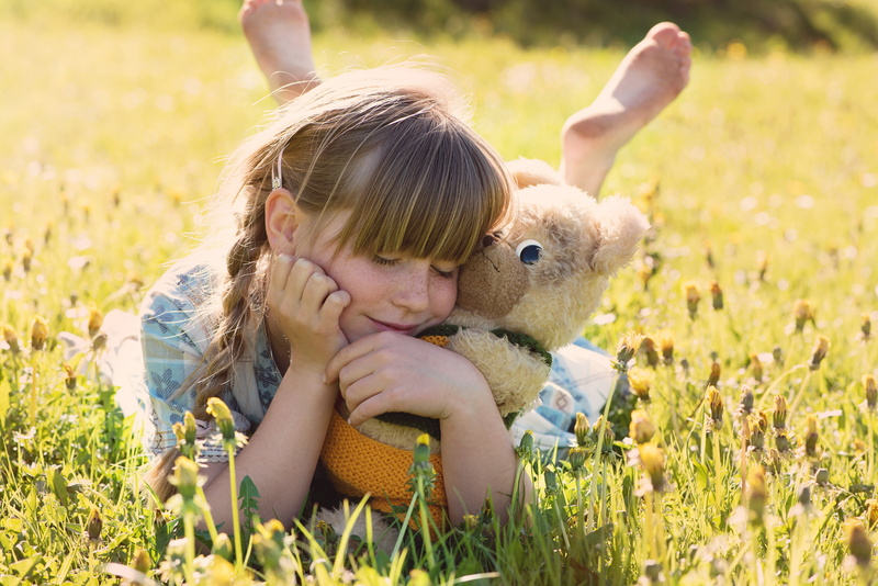 luck, field, nature, lying, childhood, hair, grass, people, children only, kids, one girl only, plant, bear, females, girl, teddy bear, person, lighting