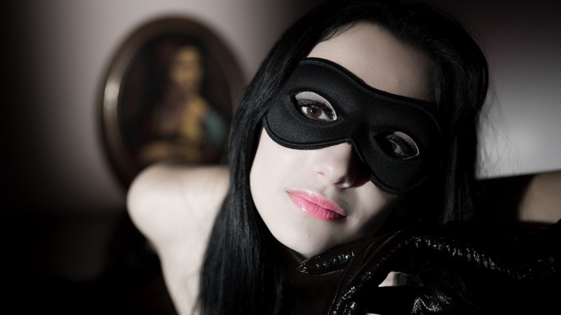 human face, looking at camera, indoors, disguise, headshot, women, young adult, venetian masks, 4K, beauty, hood - clothing, black color, hairstyle, focus on foreground