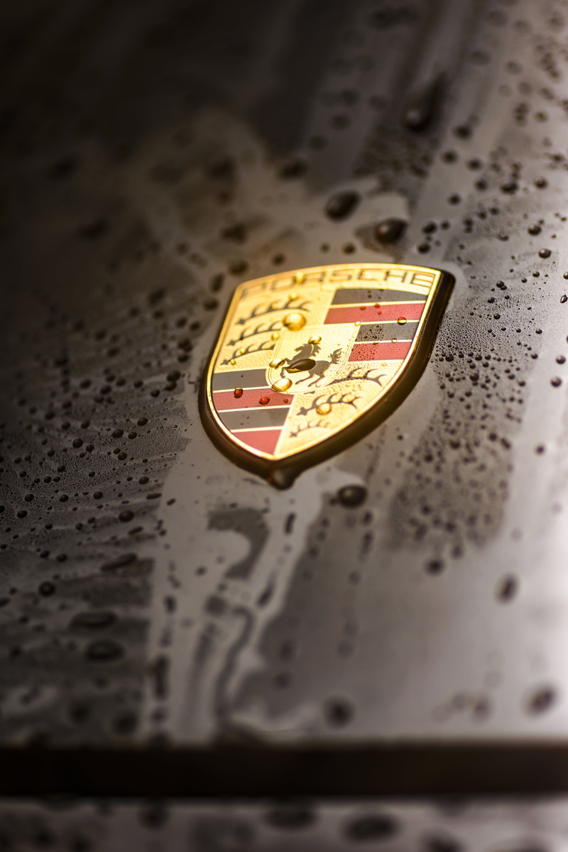 close-up, western script, indoors, coin, transport, coat, water, carrera, vehicle, metal, porsche, no people, communication, drops, badge, single object