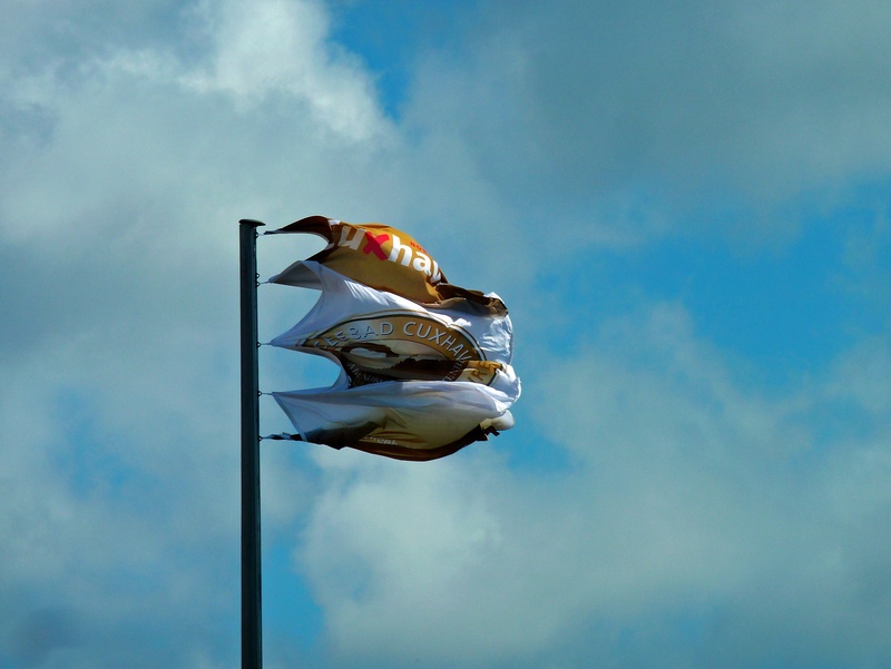 blue, skill, day, pole, strong winds, people, full length, sky, blow, real people, outdoors, occupation, since wind, unrecognizable person, nature, flag