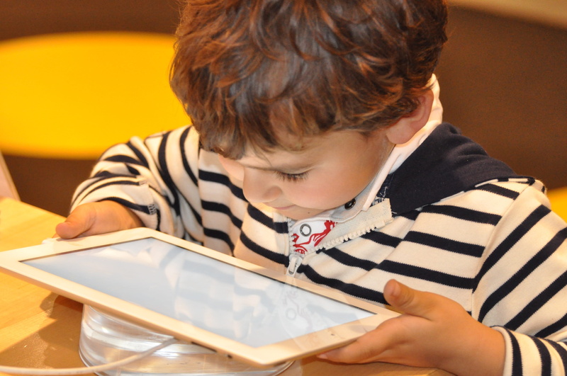 communication, one person, reading, web, digital tablet, activity, sitting, offspring, striped, white, digital native, tablet, learning, casual clothing