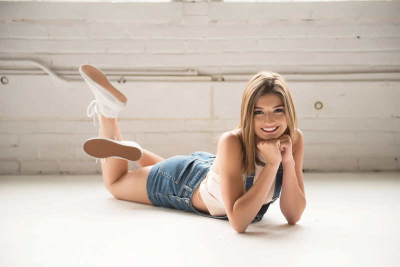 flooring, long hair, hair, bare shoulders, legs up, leisure activity, young women, blonde, jeans, one person, denim, indoors, straight hair, model, full length