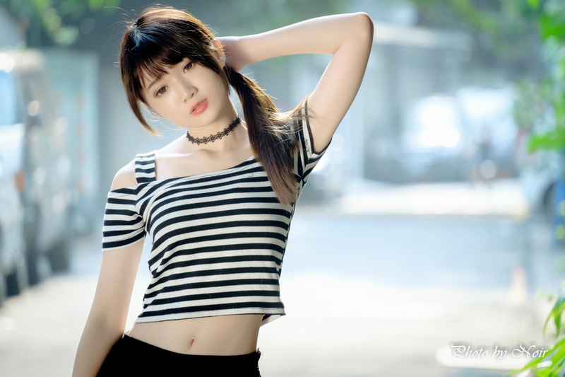 real people, choker, hair, portrait, model, standing, striped clothing, day, adult, bangs, ponytail, hands on head, women outdoors, young adult, beautiful woman