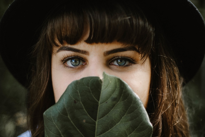 hiding, brown hair, 5K, warm clothing, eyes, women, bangs, human face, body part, looking at camera, portrait, obscured face, young women, young adult