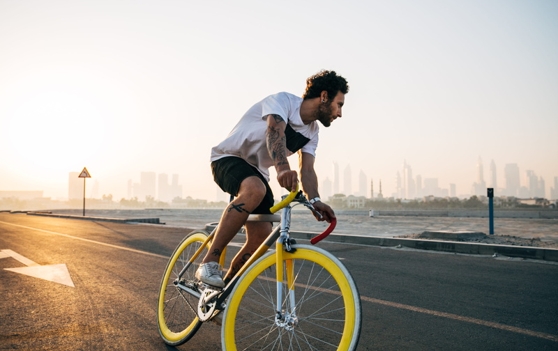 full length, guy, sports clothing, skyline, tattoo, road, riding, wearing, crew, one person, transportation, man, 2K, shirt, sunrise, lifestyles, city