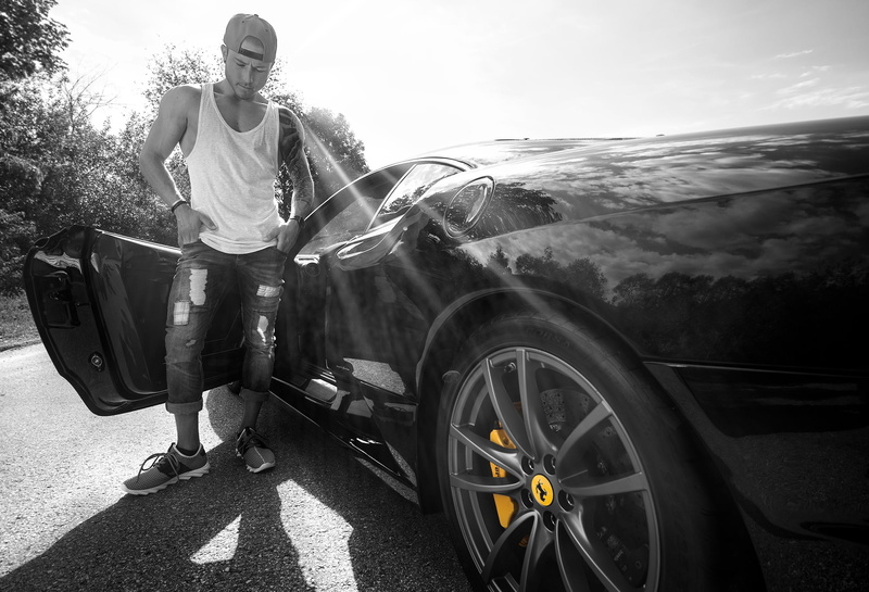 casual clothing, nature, sunlight, one person, shadow, wheel, outdoors, day, beside, adult, young adult, full length, car, one man only, people, front view