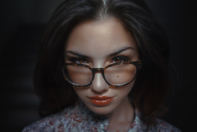 body part, model, black background, brunette, Delaia Gonzalez, looking at viewer, beautiful woman, close-up, women, hairstyle, face, portrait, eyeglasses