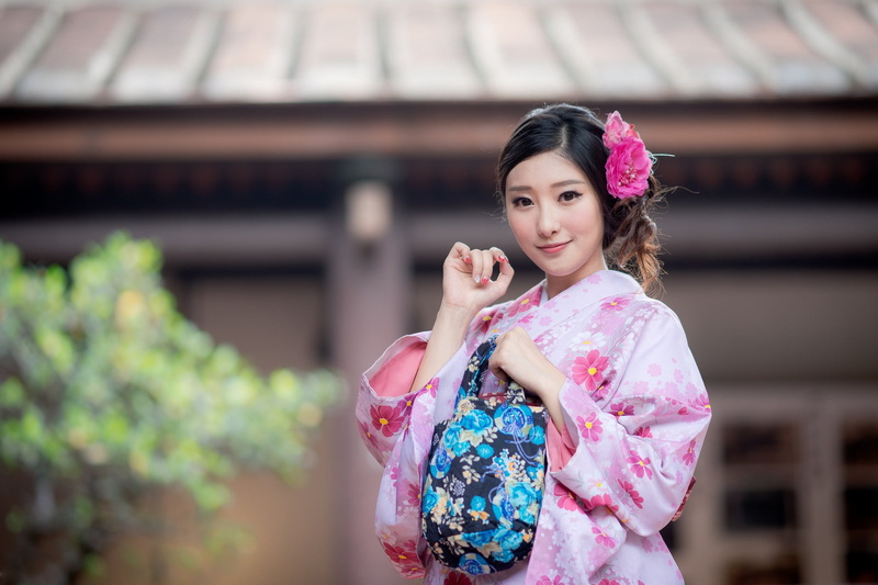 hairstyle, pink color, women, standing, real people, floral pattern, lifestyles, portrait, adult, young adult, smiling, depth of field, clothing, architecture
