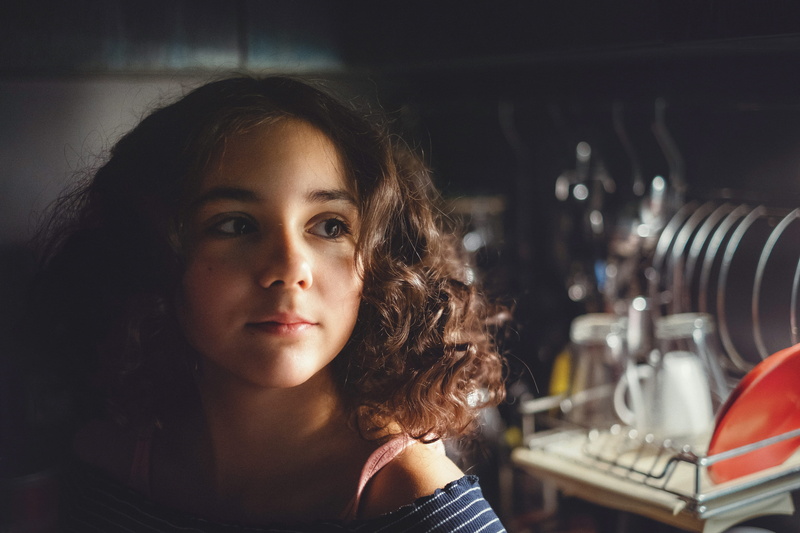 medium-length hair, brown eyes, one person, brown hair, young adult, portrait, looking at camera, sitting, near, curly hair, females, rack, hair, emotion