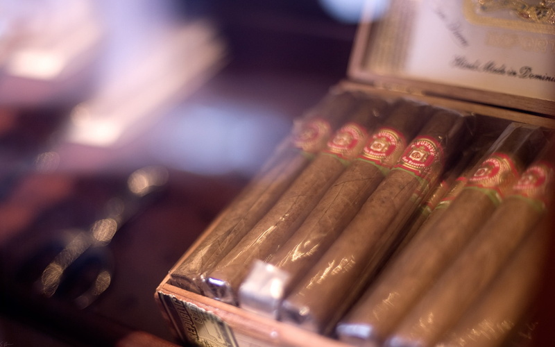 focus on foreground, cigars, number, bottle, large group of objects, finance, label, text, education, paper currency, selective focus, currency, container