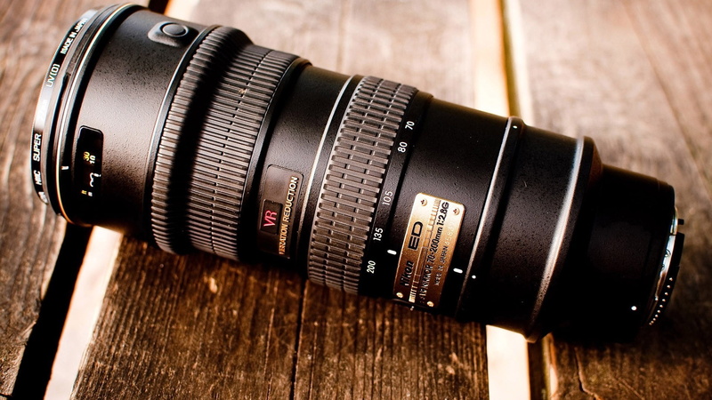 digital camera, closeup, table, focus on foreground, wooden surface, communication, slr camera, lens - optical instrument, indoors, camera - photographic equipment