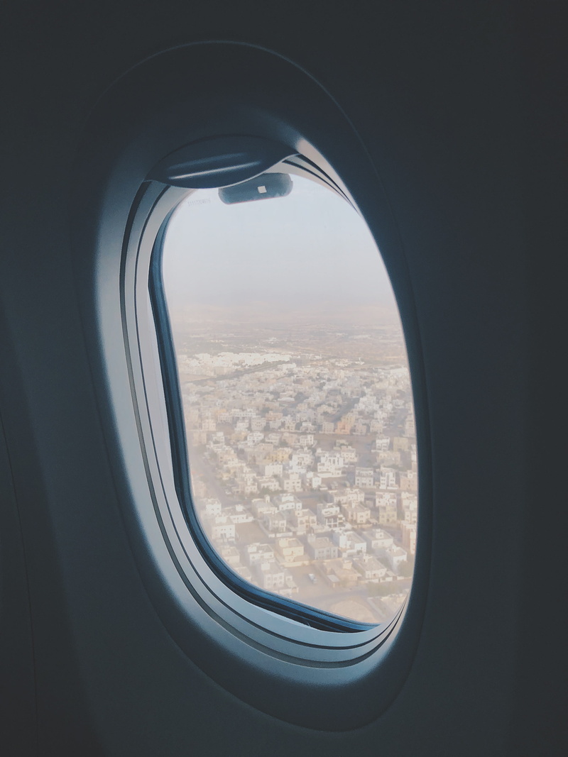 airplane, transparent, oman, unnamed road, air vehicle, sib, travel, vehicle interior, sky, cloud - sky, flying, mode of transportation, day, glass - material