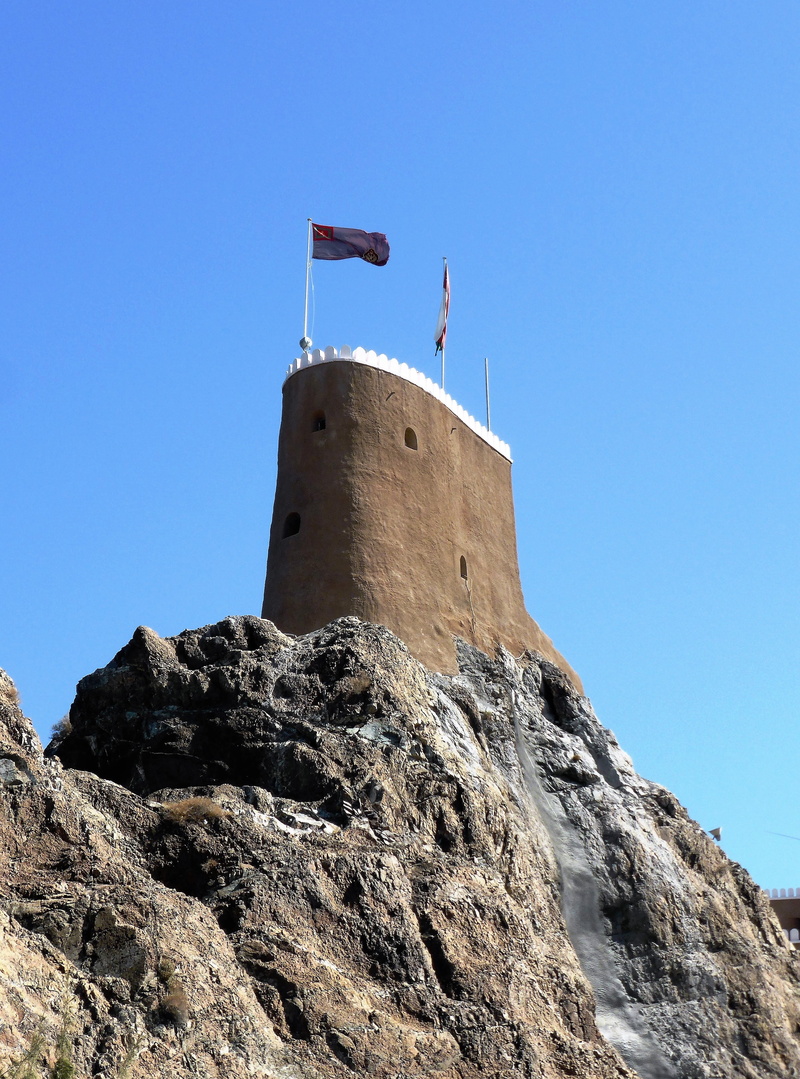 outdoors, history, guidance, architecture, clear sky, oman, fort, no people, solid, built structure, rock - object, low angle view, sky, tower, rock formation