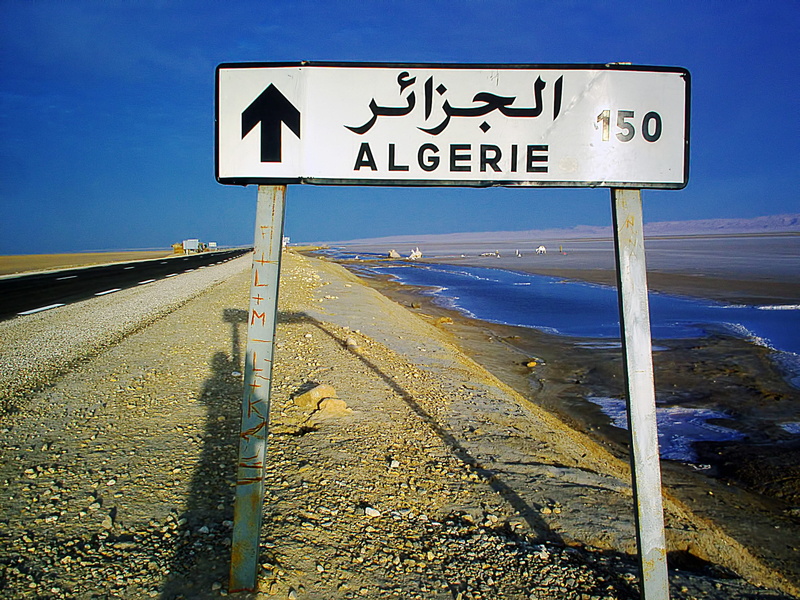 150 km, sky, sign, clear sky, signpost, land, salt lake, road sign, algiers, road, text, 2K, no people, blue, transportation, directional sign, algeria