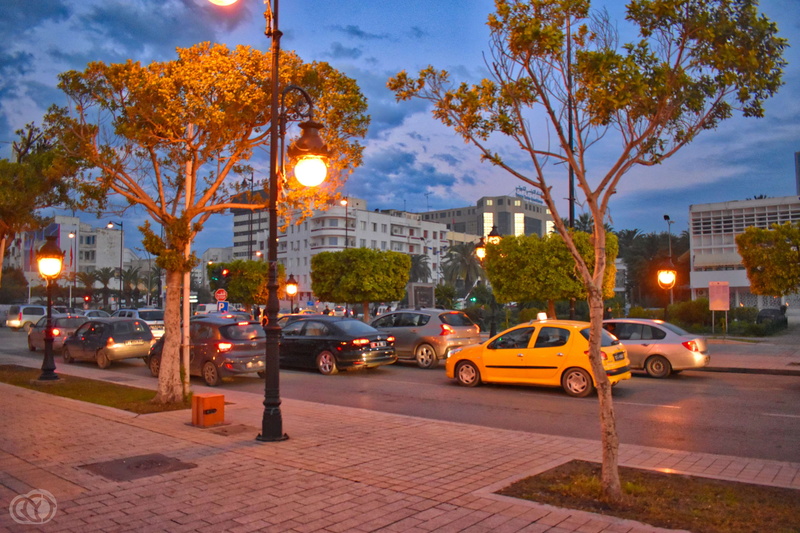 city street, tunisia, street, building exterior, car, road, taxi, lighting equipment, motor vehicle, built structure, illuminated, tree, transportation