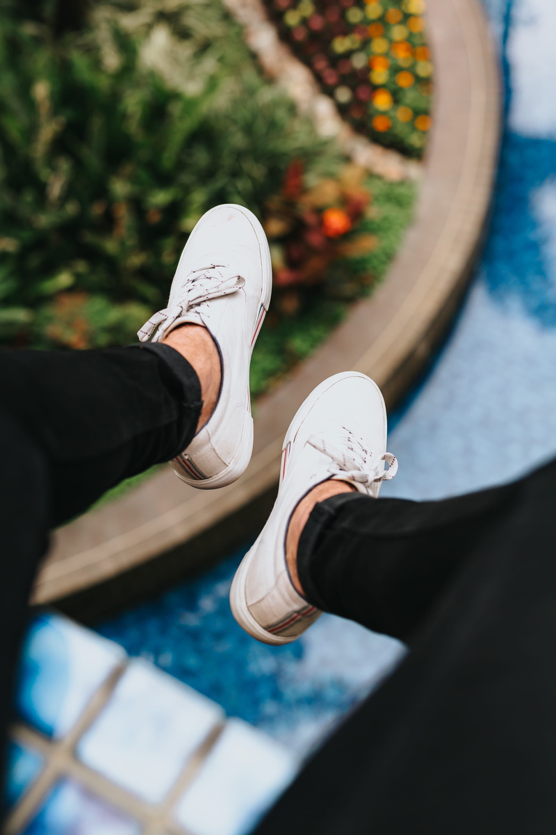 sports Shoe, sneakers, males, black pant, nature, dangle, hang, human Hand, water, white shoe, men, sneaker, daring, shoe, one Person, cliff
