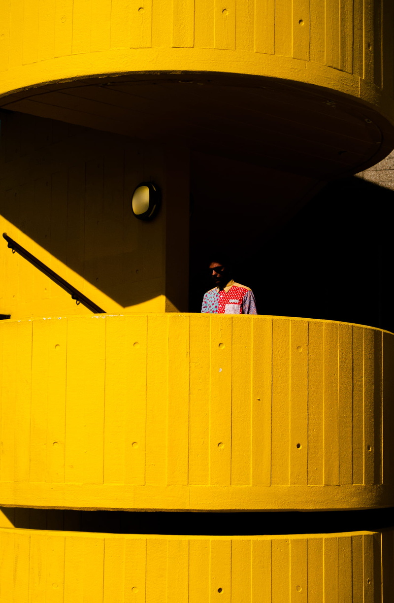 balcony, sitting, stair, near, man, brutalist, building exterior, multicolored, built structure, nature, lifestyles, shadow, 1080P, black, transportation